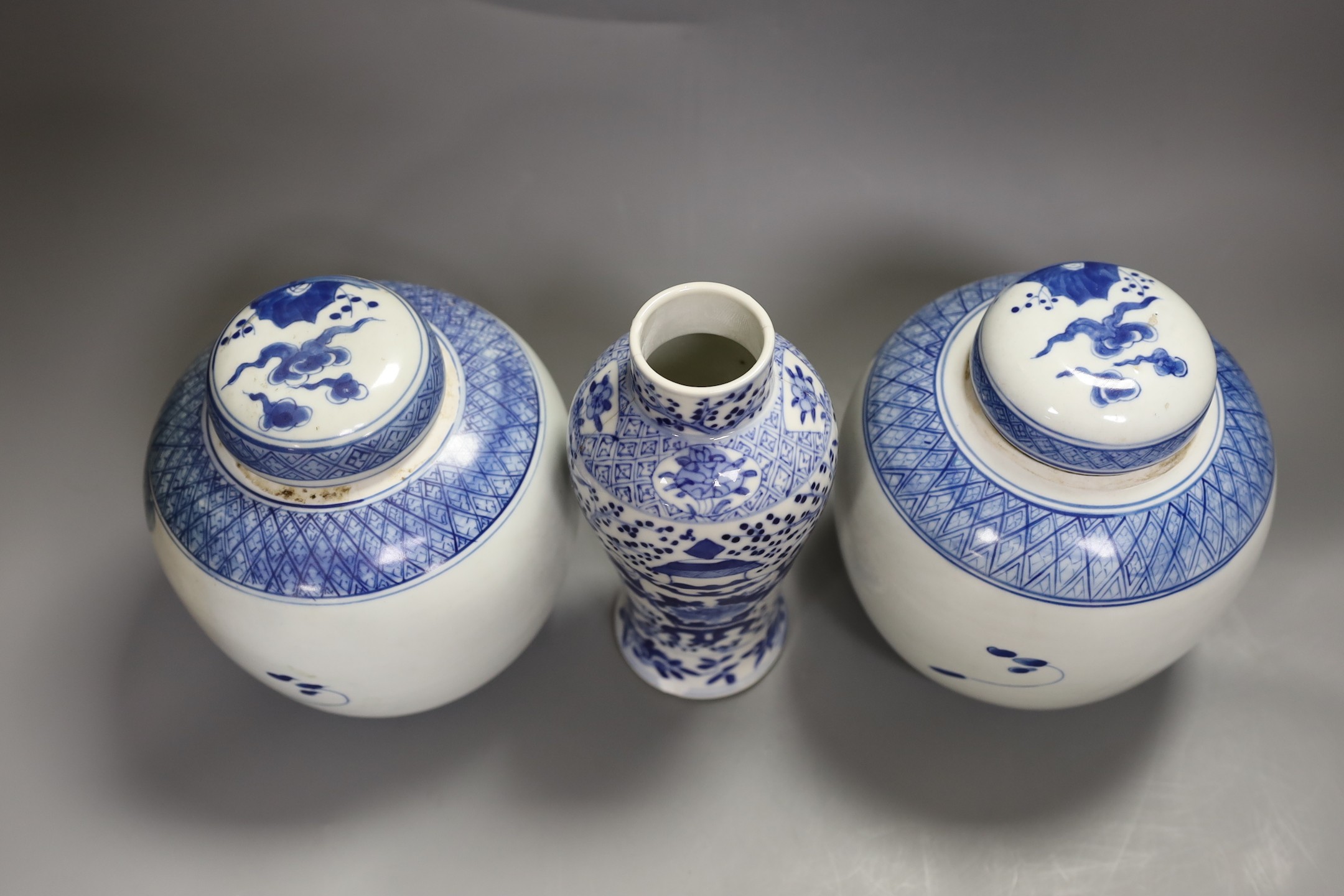 A 19th century Chinese blue and white vase (a.f) and two later jars and covers, tallest 19cm